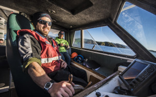 A man steering a boat